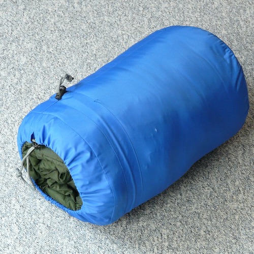 a blue sleeping bag rolled up